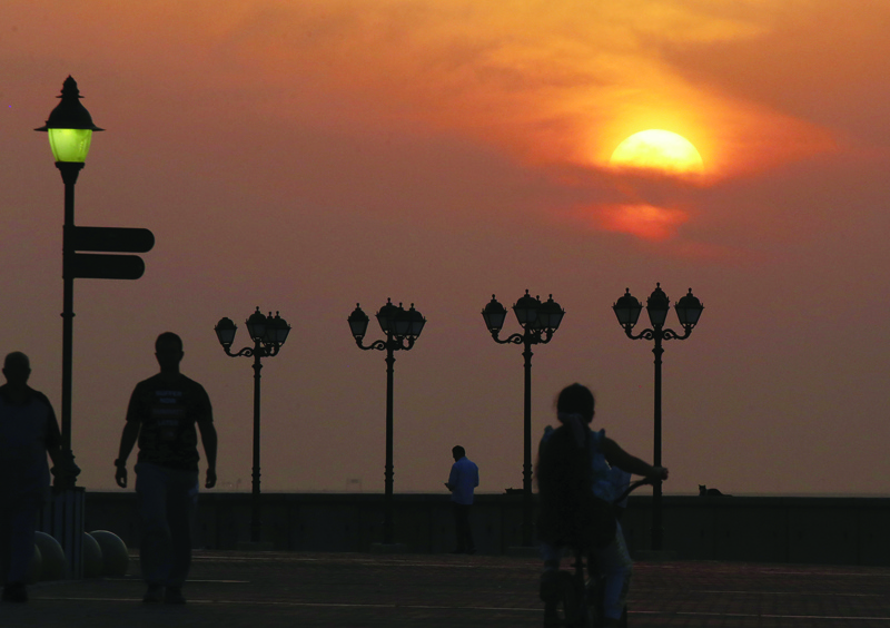 KUWAIT: People walk along the waterfront at sunset in Kuwait City on November 1, 2021. - Photo by Yasser Al-Zayyatn