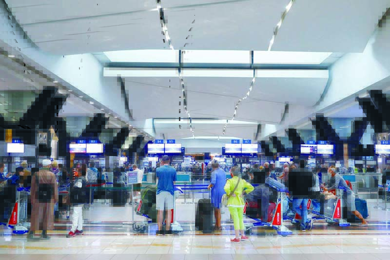 JOHANNESBURG: Travellers queue at a check-in counter at OR Tambo International Airport in Johannesburg yesterday, after several countries banned flights from South Africa following the discovery of a new COVID-19 variant Omicron. - AFPnn