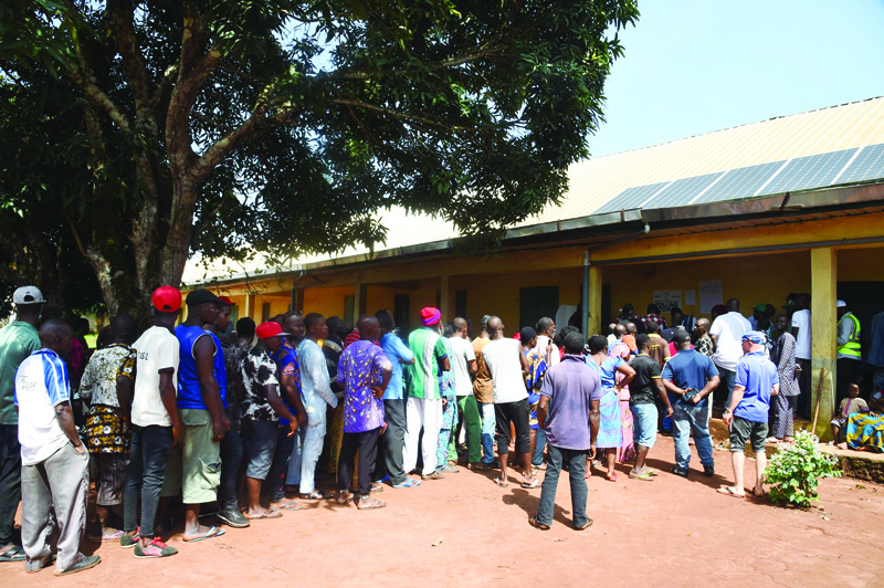 ISUOFIA, Nigeria: Voters queue to vote at a polling station during the Anambra State governorship election at Isuofia, southeast Nigeria yesterday. - AFP n