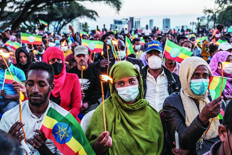 ADDIS ABABA: People hold candles and Ethiopian flags during a memorial service for the victims of the Tigray conflict organized by the city administration, in Addis Ababa, Ethiopia. - AFP n