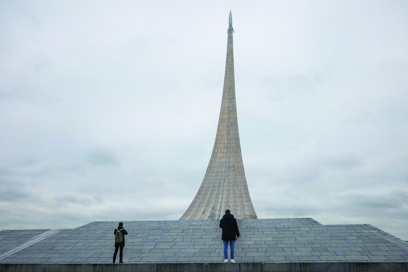 MOSCOW: People stand at the Monument to the Conquerors of Space, bearing the model of a rocket, on top of the National Cosmonautics museum in Moscow. Russia has admitted to destroying one of its satellites during a missile test, but rejected US accusations that it had endangered the International Space Station. - AFP n