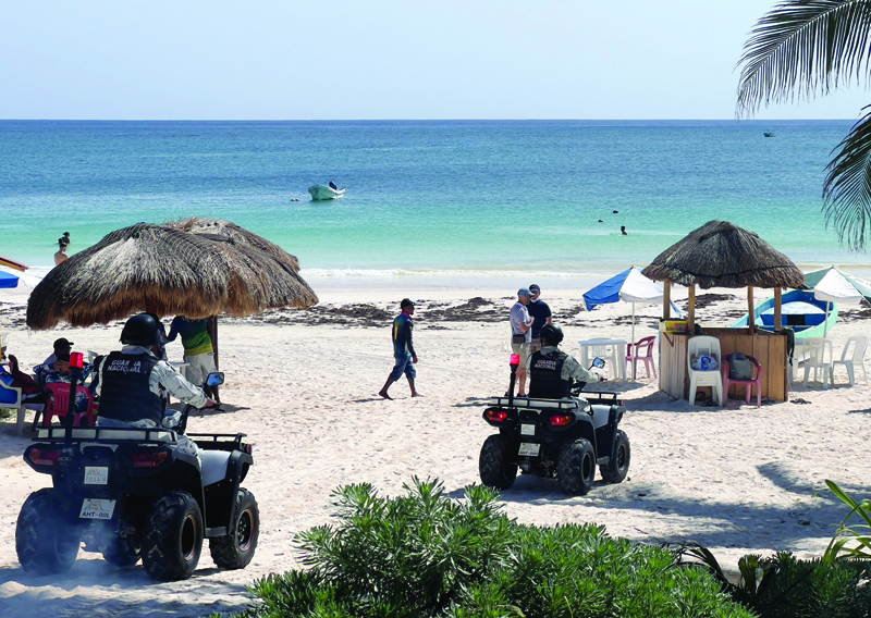 TULUM: Police officers patrol Tulum beach, near the Pre-Columbian Mayan archaeological site of Tulum, close to Mexico's Caribbean beach resort of Tulum, in the Mayan Riviera, Quintana Roo State. - AFP n