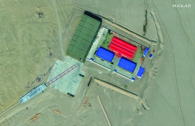 RUOQIANG: This handout satellite image shows a rail terminus and a target storage building in Ruoqiang county in the Taklamakan Desert, China's western Xinjiang region. - AFP n