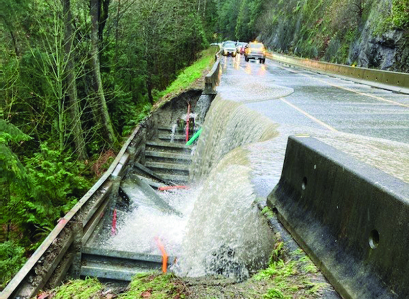 MALAHAT, Canada: Photo shows storm water on the Malahat Highway on Vancouver Island. Relentless rain battered Canada's Pacific coast - forcing a town's evacuation and trapping motorists as mudslides, rocks and debris were washed across major highways. - AFP