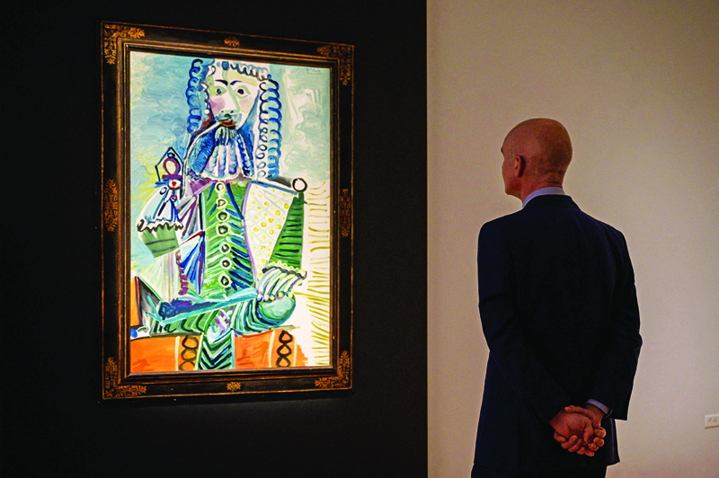 A painting by Pablo Picasso entitled 'Mousquetaire à la pipe II' is displayed at Christie's auction house in New York.—AFP photosn