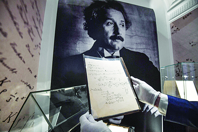 A picture shows pages of one of the preparatory manuscript to the theory of general relativity of Albert Einstein, during their presentation a day before being auctioned at Christie's auction house in Paris.-AFP photosn