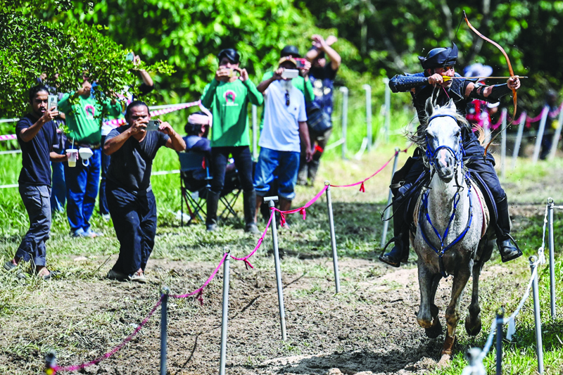This picture shows Zaharudin Rastam Yeop Mahidin marking his target during a Horseback Archery League competition at Cape Cavallho Equestrian Club in Rembau, Malaysia's Negeri Sembilan state.-AFP photosn