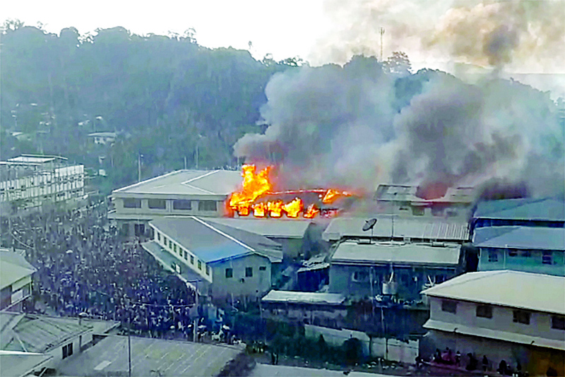 HONIARA, Solomon Islands: This screengrab taken and received yesterday from a video from ZFM Radio shows parts of the Chinatown district on fire in Honiara on Solomon Islands, as rioters torched buildings in the capital in a second day of anti-government protests. -- AFPnn