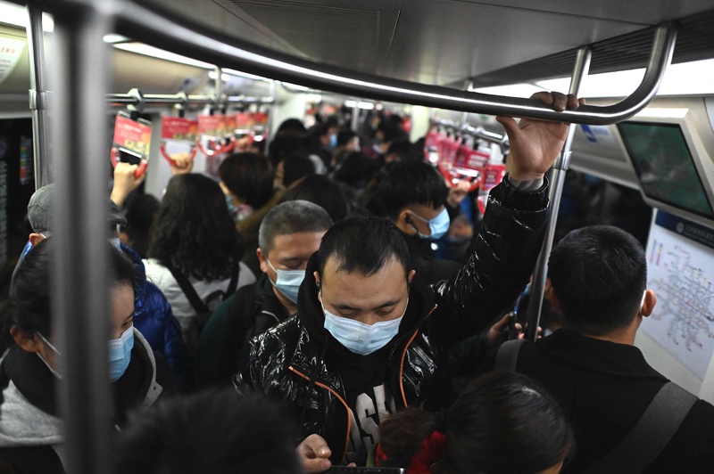 BEIJING: Commuters ride the subway during evening rush hour in Beijing yesterday. - AFP n