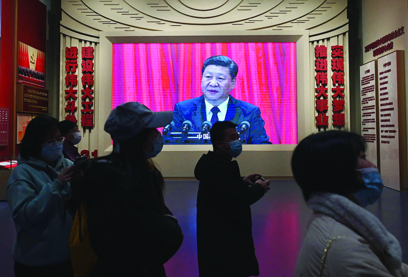 BEIJING: China's President Xi Jinping is seen in a big screen during an evening news program in Beijing yesterday, as top Communist Party leaders wrapped up a key meeting by passing an important resolution on the country's past, state media said, which is expected to cement President Xi Jinping's grip on power. - AFPnn n