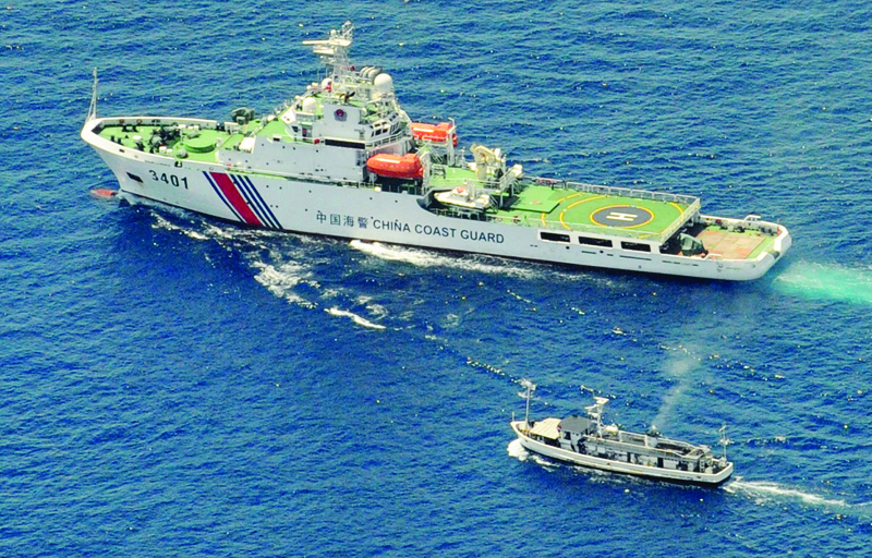 AT SEA, PHILIPPINES: File photo shows a China Coast Guard ship (top) and a Philippine supply boat engaging in a stand off as the Philippine boat attempts to reach the Second Thomas Shoal, a remote South China Sea a reef claimed by both countries. - AFPnn