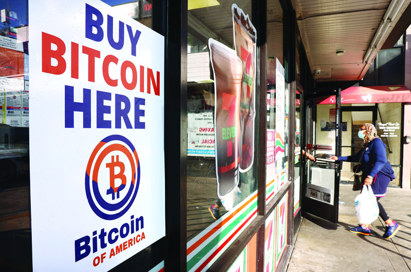 LOS ANGELES: A 'Buy Bitcoin Here' sign is posted at a 7-Eleven store in Los Angeles, California. The price of the cryptocurrency hit a new record high - nearly breaking through $69,000 as inflation has risen to a level not seen in 30 years. - AFP n