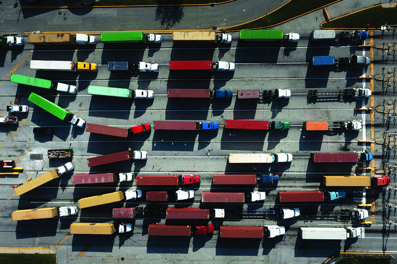 BALTIMORE, US: Trucks transport cargo containers at the Port of Baltimore in Baltimore, Maryland. – AFPnn