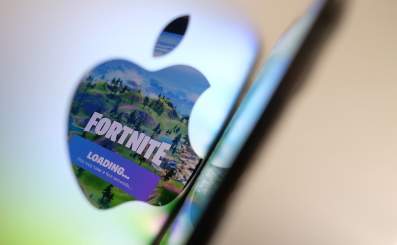 LOS ANGELES: The opening screen of Epic Games’ Fortnite reflected onto the Apple logo of the back of an iMac computer in Los Angeles.-- AFPnn