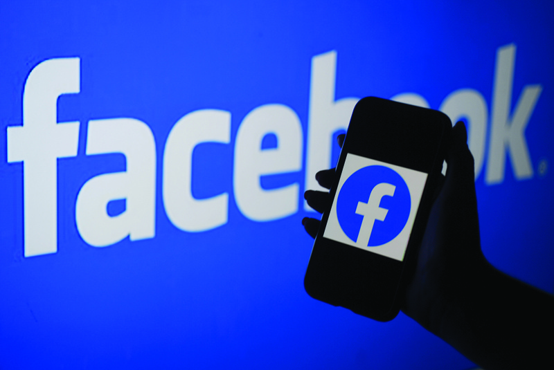 ARLINGTON: In this file illustration photo, a smart phone screen displays the logo of Facebook on a Facebook website background in Arlington, Virginia.-AFPn