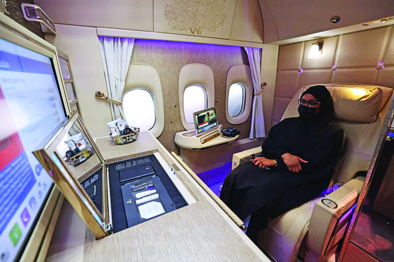 DUBAI: A visitor sits inside a mock-up business class cabin of Emirates airlines at the 2021 Dubai Airshow in the Gulf emirate, yesterday. – AFPnn
