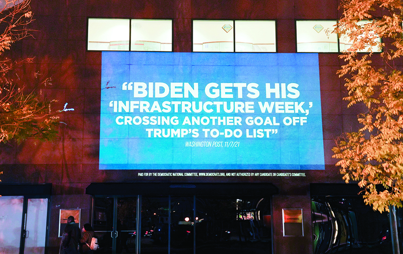 BALTIMORE, Maryland: DNC celebrates President Biden and Democrats delivering on the Bipartisan Infrastructure Deal by projecting video on a wall in the Inner Harbor of Baltimore on November 9 in Baltimore, Maryland. - AFPn