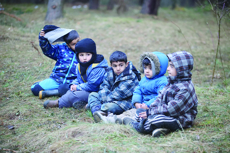 BELARUSIAN-POLISH BORDER: Photo shows children in a migrants camp on the Belarusian-Polish border in the Grodno region. —AFP