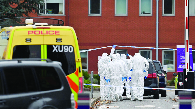 LIVERPOOL: Police forensics officers work outside the Women's Hospital in Liverpool yesterday - the scene of yesterday's taxi explosion. - AFP n