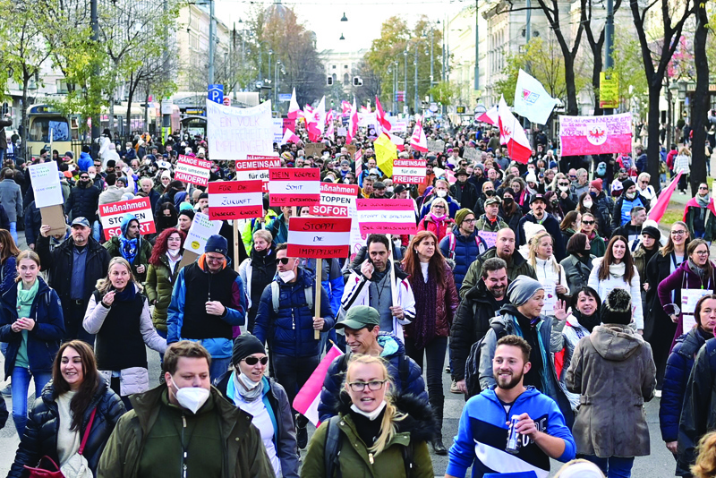 VIENNA: Demonstrators take part in a rally held by Austria's far-right Freedom Party FPOe against the measures taken to curb the coronavirus (COVID-19) pandemic, at Maria Theresien Platz square in Vienna yesterday. - AFP n
