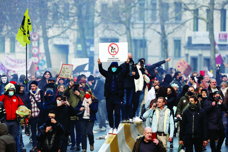 BRUSSELS: People take part in a demonstration against Belgium government's measures to curb the spread of the COVID-19 and mandatory vaccination in Brussels yesterday. - AFPnn