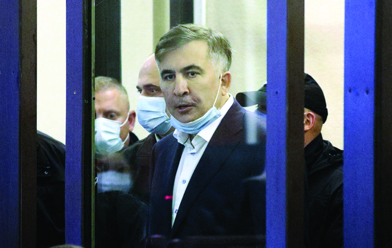 TBILISI: Georgia's jailed opposition leader and ex-president Mikheil Saakashvili arrives in the defendant's box for an earing at the city court of Tbilisi yesterday. - AFPnn