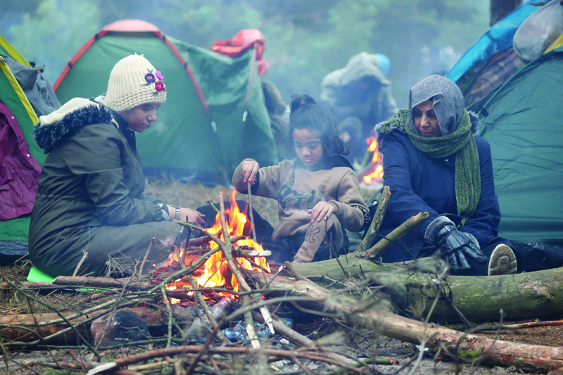 GRODNO: Photo shows migrants in a camp on the Belarusian-Polish border in the Grodno region. - AFP n