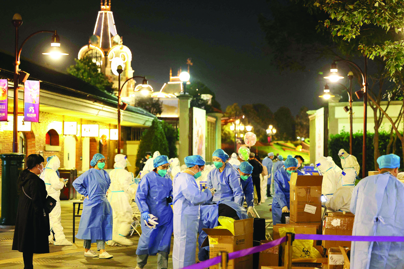 SHANGHAI: Medical personnel prepare to test visitors for the COVID-19 coronavirus at Disneyland in Shanghai after a single coronavirus case was detected at the park on the weekend. – AFP n