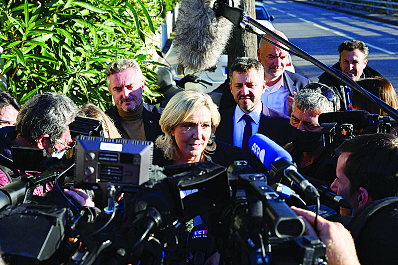 MARSEILLE: Leader of French far-right party Rassemblement National (RN) and candidate for the 2022 French presidential election Marine Le Pen (C) answers journalists' questions after visiting a police station in the northern neighbourhoods of Marseille. - AFPnn
