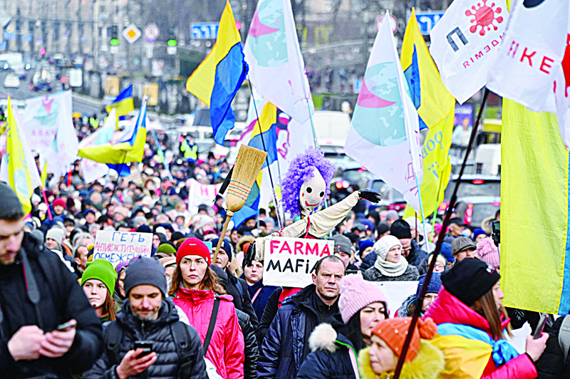 KIEV: Anti-vaccine protesters rally in Kiev yesterday. Hundreds of protesters blocked roads in central Kiev yesterday to demonstrate against Ukraine's anti-COVID measures and vaccine drive, as the country battles a fresh wave of infections. - AFPnn