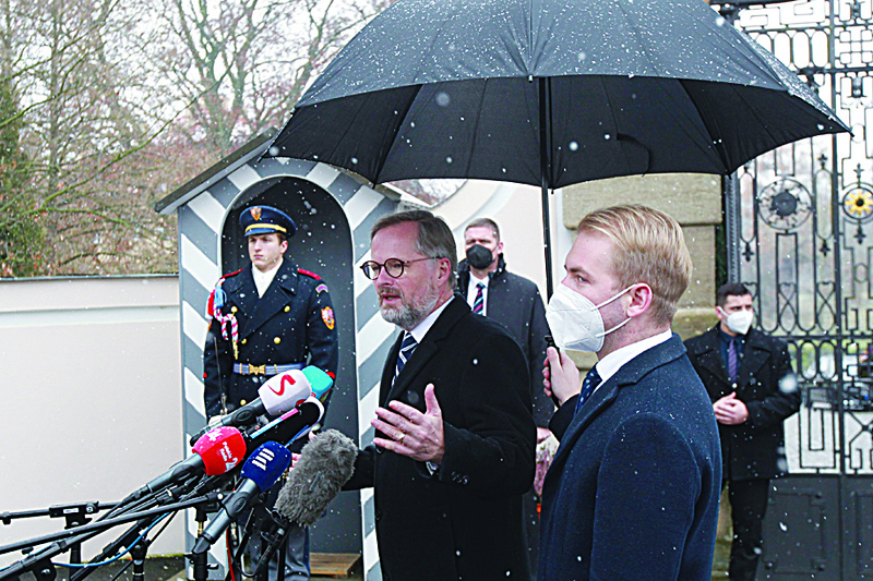 LANY, Czech Republic: Newly-appointed Czech Prime Minister Petr Fiala (center), a former political scientist, gives a press statement in Lany, west of Prague, Czech Republic, yesterday.-AFPnn