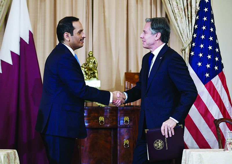 WASHINGTON: US Secretary of State Antony Blinken and Qatar’s Foreign Minister Sheikh Mohammed Al-Thani shake hands during a signing ceremony at the State Department on Friday. — AFP