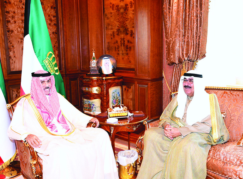 KUWAIT: His Highness the Amir Sheikh Nawaf Al-Ahmad Al-Jaber Al-Sabah meets His Highness the Crown Prince Sheikh Mishal Al-Ahmad Al-Jaber Al-Sabah at Dar Al-Yamama yesterday. - Amiri Diwan photon