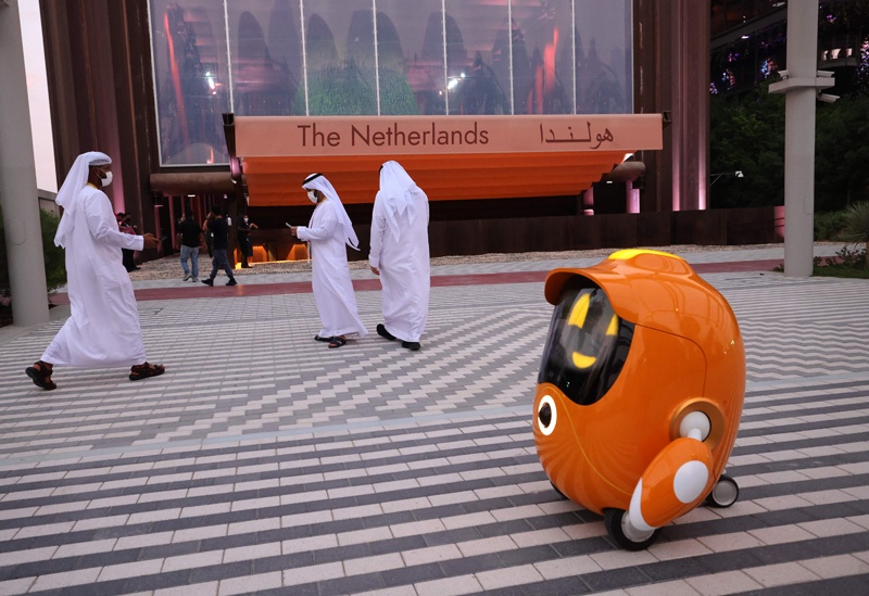DUBAI: In this photo taken on Oct 2, 2021, visitors walk past a robot outside the Dutch pavilion at the Dubai Expo 2020. – AFP n