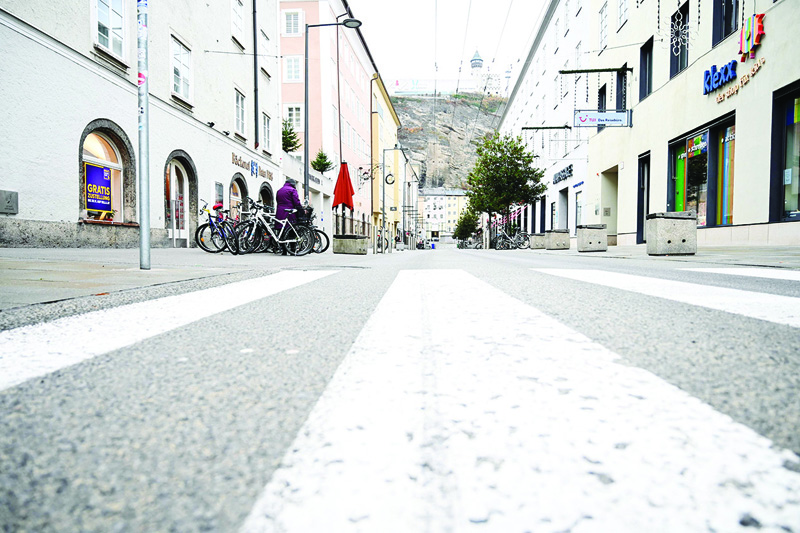 SALZBURG: A deserted shopping street is seen in the Austrian city of Salzburg yesterday, as the country returns to a nationwide partial lockdown during the ongoing coronavirus (COVID-19) pandemic. - AFP n