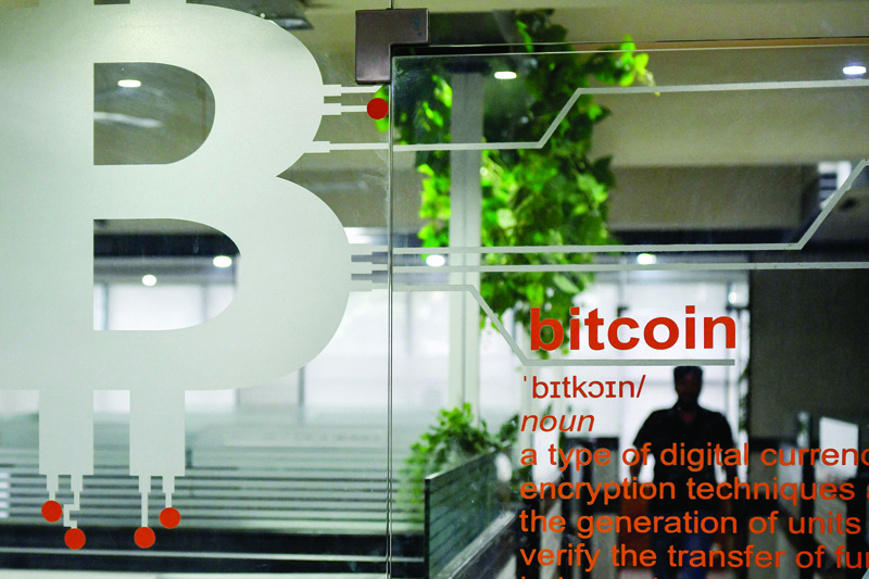 BANGALORE: The cryptocurrency symbol of Bitcoin is pictured at the entrance of a private office in Bangalore. - AFP n