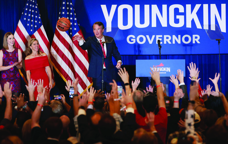 CHANTILLY, Virginia: Virginia Republican gubernatorial candidate Glenn Youngkin shoots an autographed basketball into the crowd with his family at an election night rally on Tuesday. - AFP n