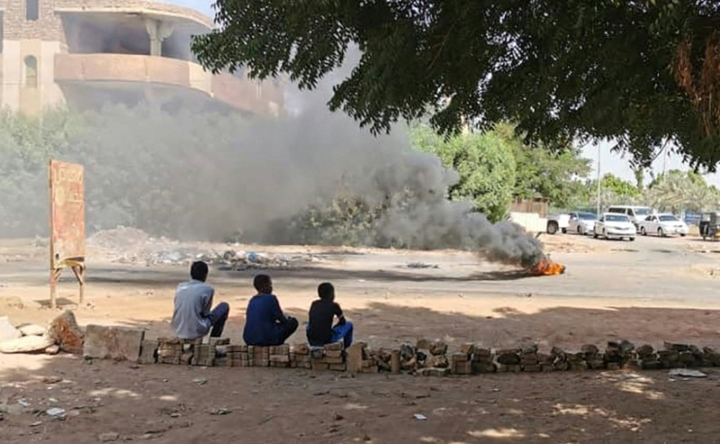 KHARTOUM: Young Sudanese sit on a street barricade built overnight by anti-coup demonstrators in the capital following calls for civil disobedience yesterday. – AFP n