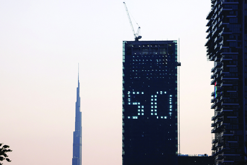 DUBAI: The number 50 is displayed on a building in the Gulf emirate of Dubai with the Burj Khalifa in the background - celebrating the upcoming United Arab Emirates' 50th anniversary which falls on December 2. - AFP n