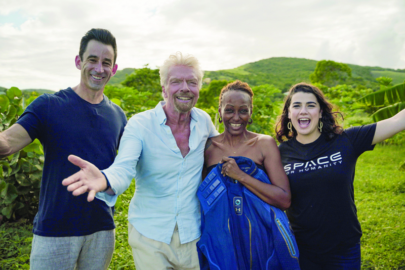 In this Handout photo Omaze CEO and co-founder Matt Pohlson (left), Sir Richard Branson (second left), Keisha S (second right), and Space For Humanity executive director Rachel Lyons (right) pose for a photo after the sweepstakes announcement in Antigua.-AFPn
