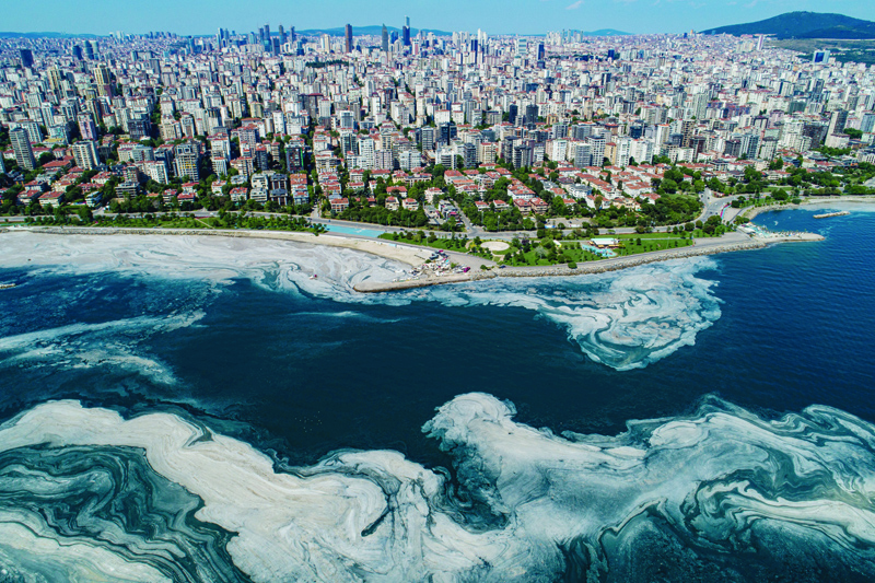 ISTANBUL: This aerial photograph taken on June 6, 2021 in Turkey's Marmara Sea at a harbor on the shoreline of Istanbul, shows a jelly-like layer of slime that develops on the surface of the water due to the excessive proliferation of phytoplankton, gravely threatening the marine biome. - AFPnn