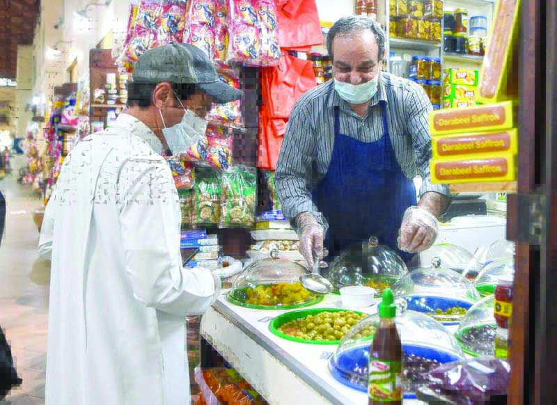 KUWAIT: This file photo shows a clerk serving a customer at his shop in Souq Mubarakiya in Kuwait City. The photo is used for illustration purposes only.n