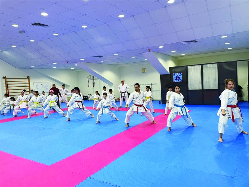 Karate players perform a kata during a practice session at a gym in Kuwait. — Kuna