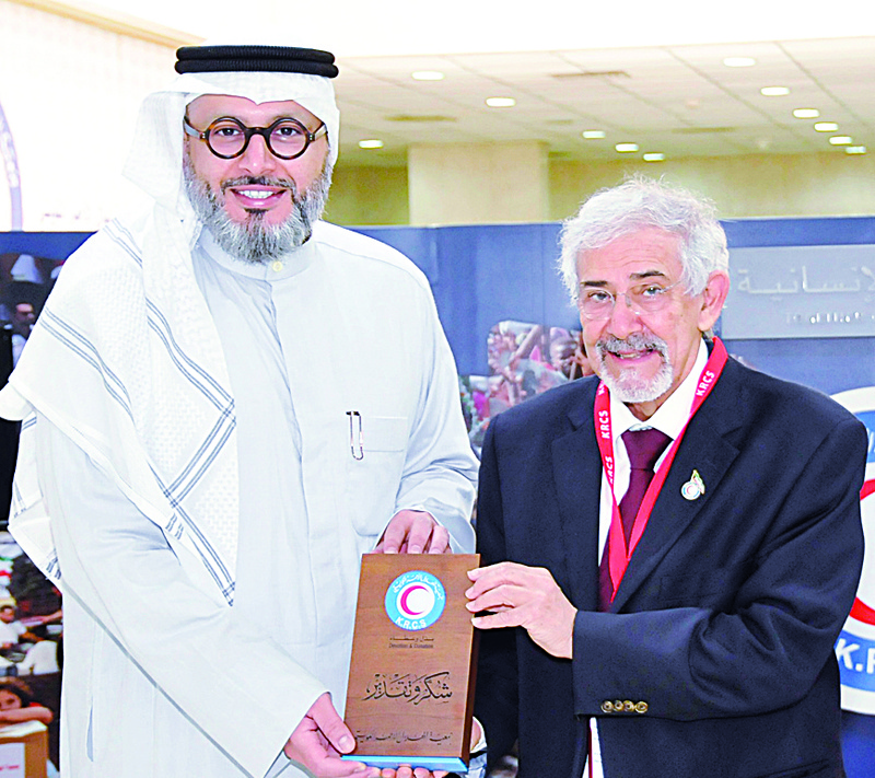 KUWAIT: Dr Hilal Al-Sayer, Chairman of the Kuwait Red Crescent Society (right) presents a memento to Naser Al-Sanousi, Marketing and Communication Director at Boursa Kuwait.n