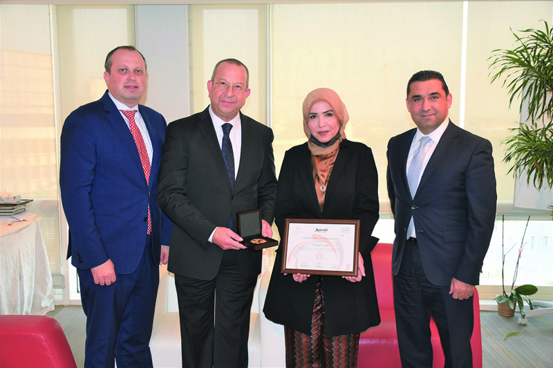 KUWAIT: Mounir Amer, General Manager of Four Points Hotel Kuwait and Mazen Mhanna, the Deputy General Manager of Sheraton Kuwait Hotel present a certificate of appreciation to Dr Awatef Al Shammeri, Head of the Tuberculosis Control Unit.n