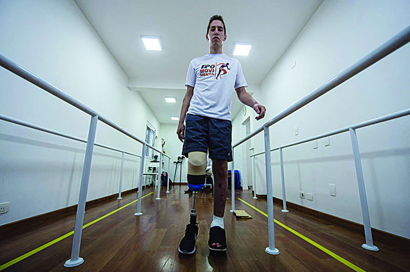 In this file photo former goalkeeper of the Brazilian football team Chapecoense, Jakson Follmann, a survivor of an airplane crash in Colombia in 2016 in which most of his teammates perished, walks during a rehabilitation session at a clinic in Sao Paulo, Brazil.-AFP n