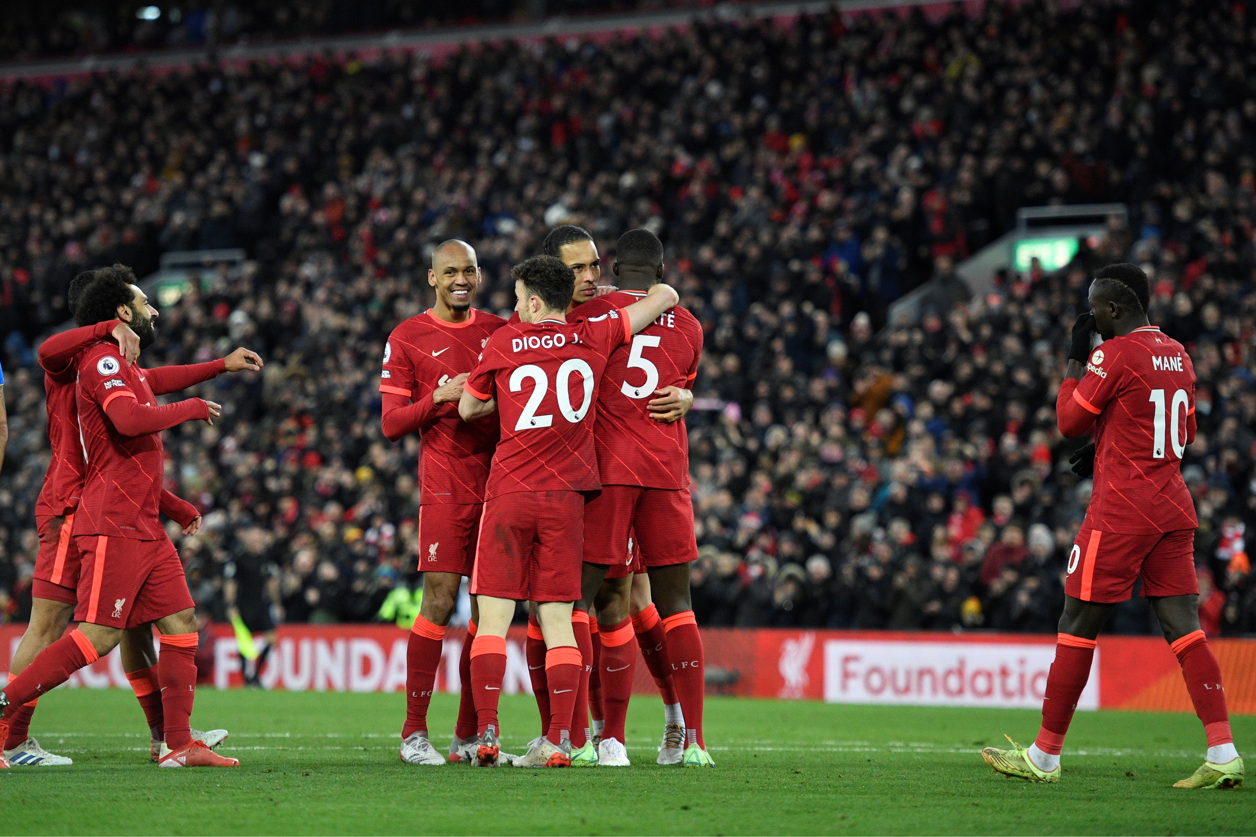 LIVERPOOL: Liverpool's Dutch defender Virgil van Dijk (second right) celebrates with teammates after scoring his team's fourth goal during the English Premier League football match between Liverpool and Southampton at Anfield in Liverpool, north west England yesterday. - AFPn