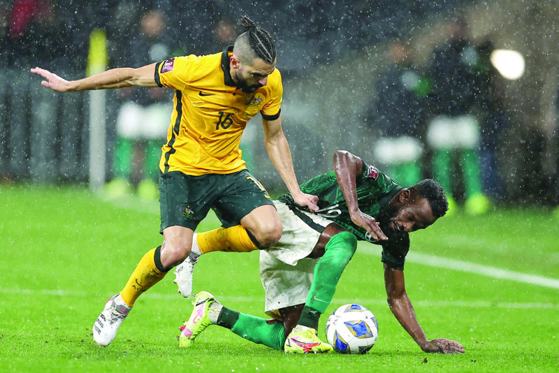 SYDNEY: Saudi Arabia's Fhad Mosaed Almuwallad and Australia's Aziz Behich fight for the ball during the World Cup Qatar 2022 qualifying football match at CommBank Stadium yesterday. – AFP n