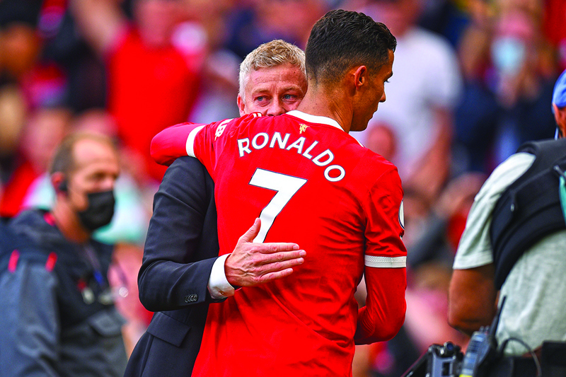 MANCHESTER: n this file photo taken on September 11, 2021 Manchester United's manager Ole Gunnar Solskjaer embraces striker Cristiano Ronaldo after the English Premier League football match against Newcastle at Old Trafford in Manchester, north west England. – AFPn