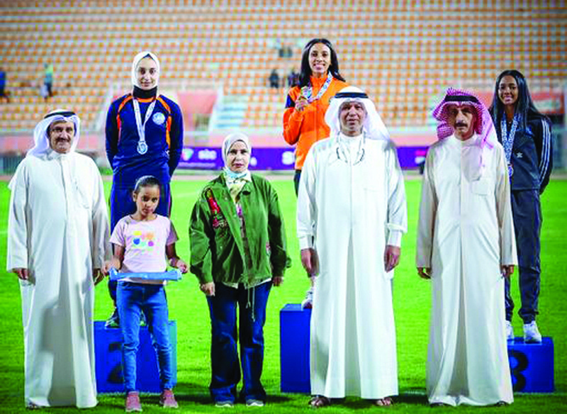 KUWAIT: Salwa club's runner Mudhawi Al-Shimmari (center) poses with her gold medal in the 100 meters on the first day of the Kuwait women's athletics season.n